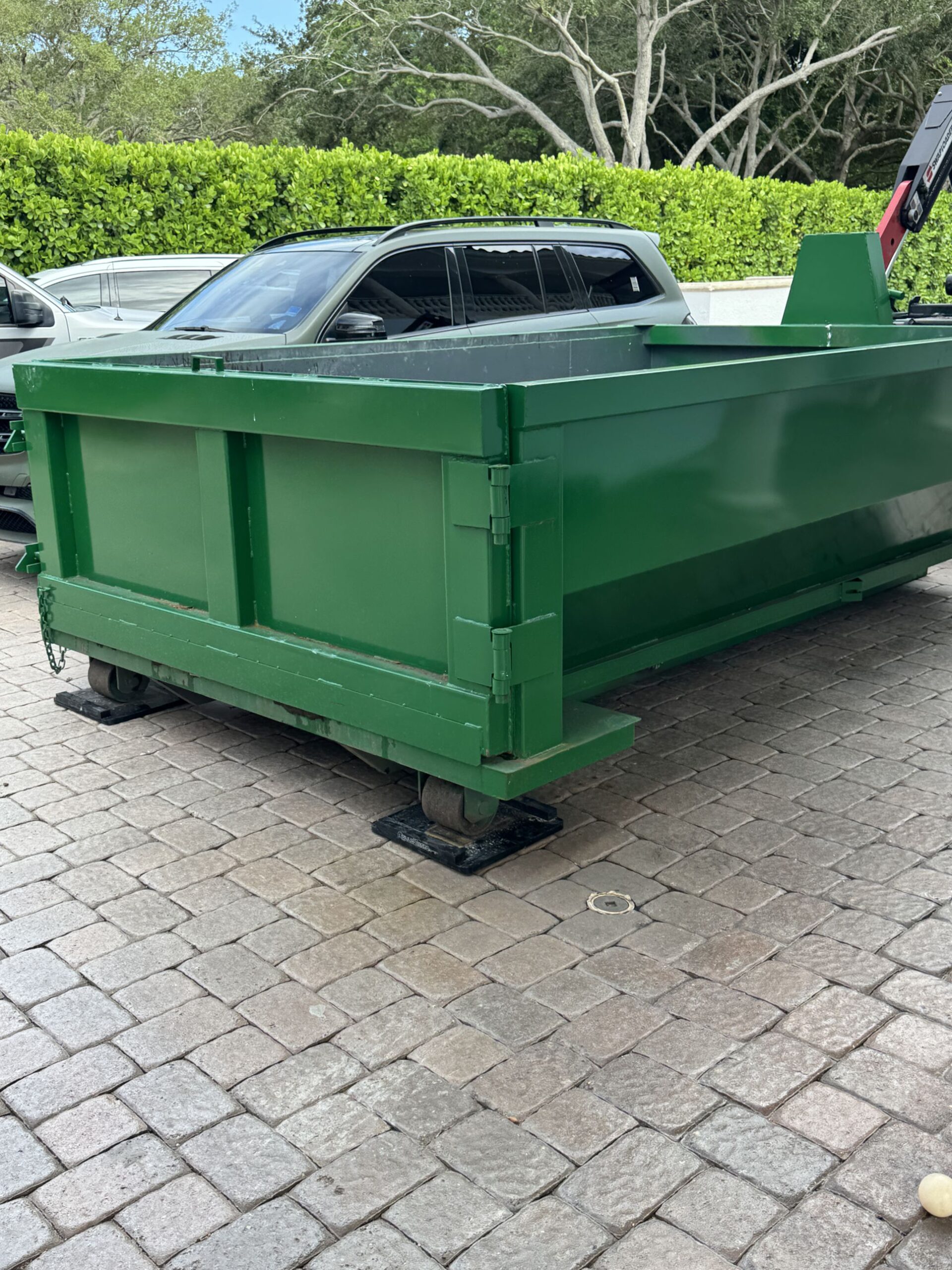 Driveway protection boards under roll-off dumpster in Palm Beach County, FL